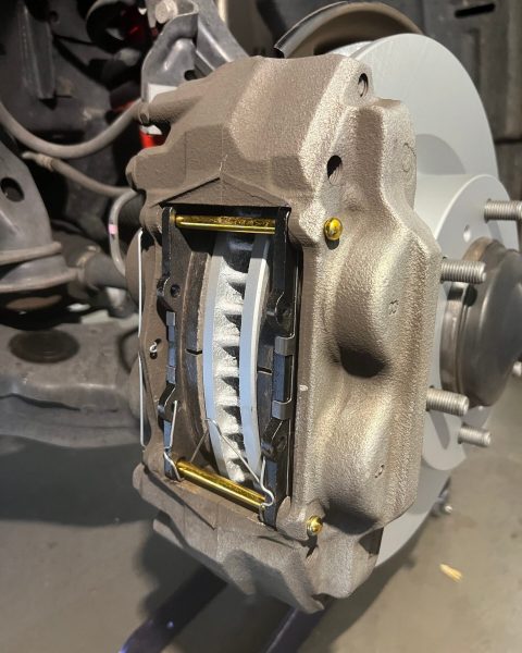 Brake caliper and pads installed over a rotor