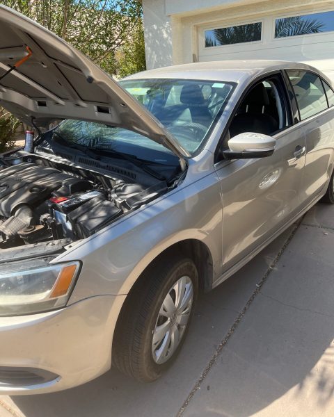 Volkswagen sedan parked in a driveway, ready for an on-site brake service